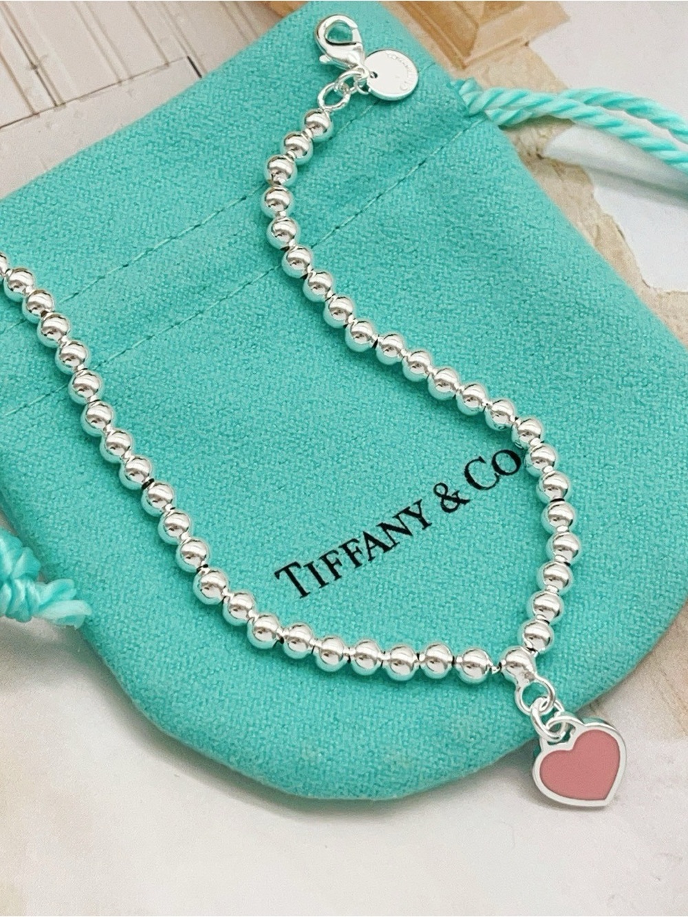 Tiffany & Co. Silver Bead Bracelet with Pink Heart Charm